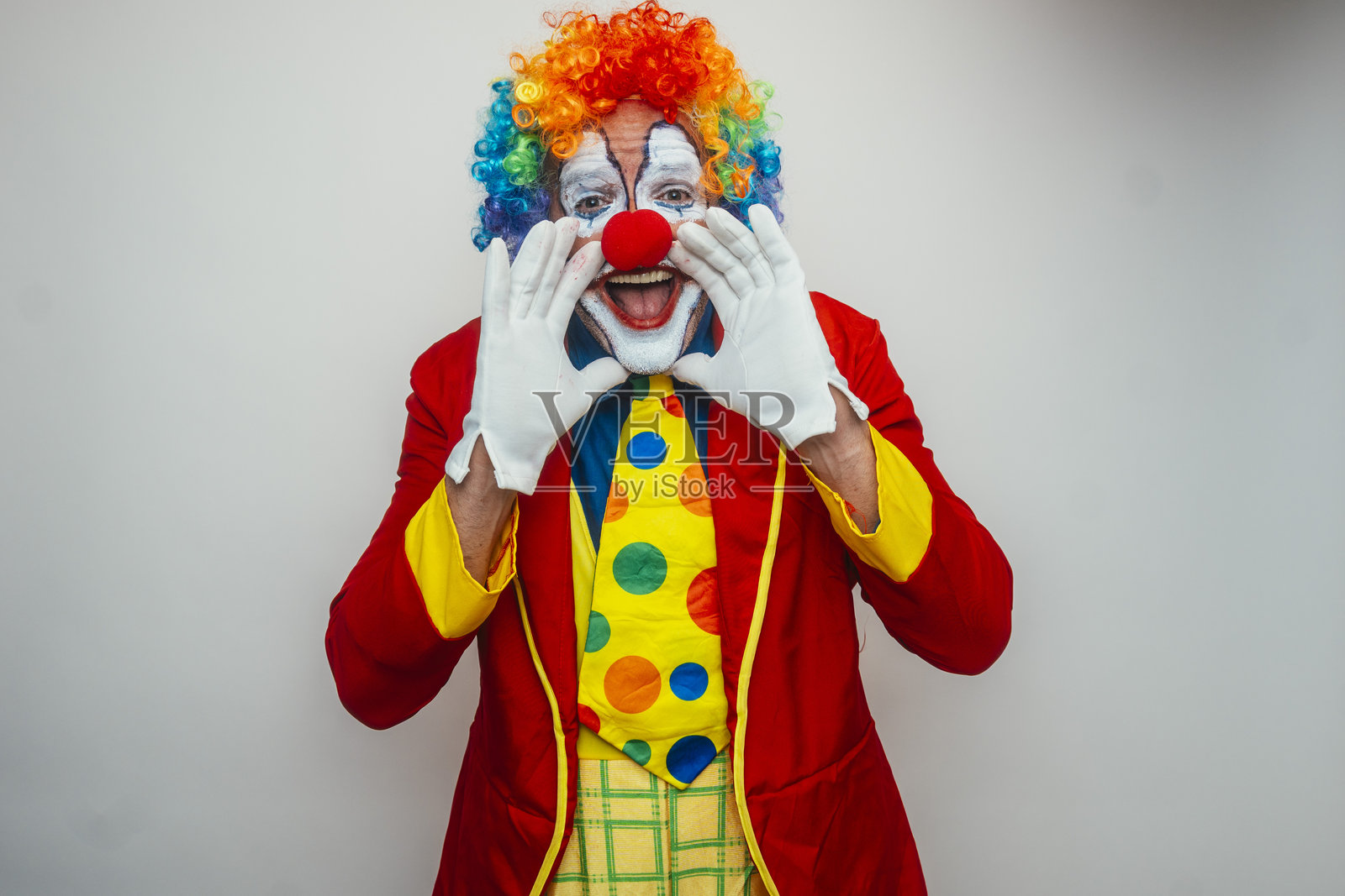 小丑用手指做望远镜照片摄影图片