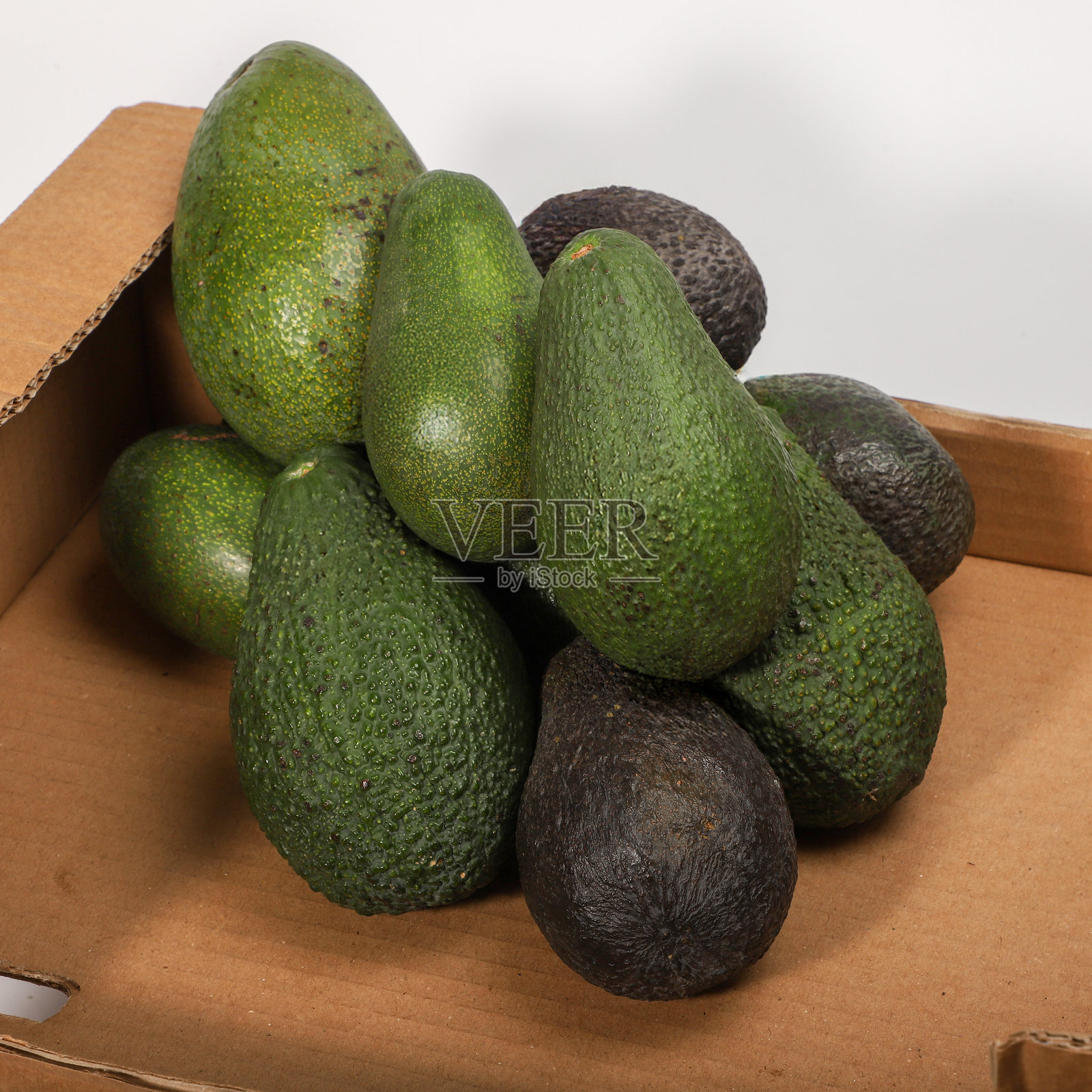 白色背景上的纸箱展示新鲜鳄梨照片摄影图片