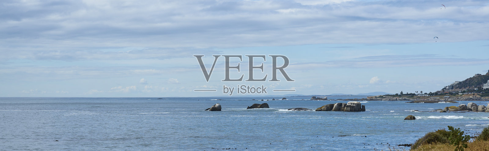 南非开普敦附近岩石海岸的风景，宁静的多云天空下。照片摄影图片