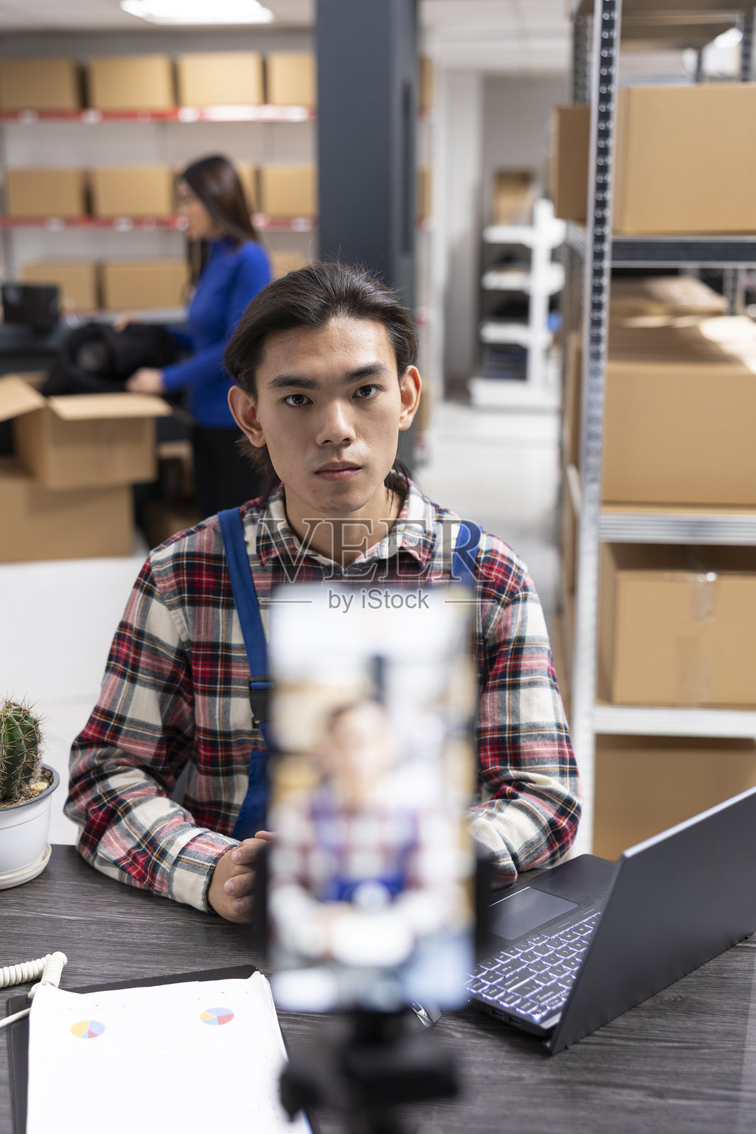 小企业主使用智能手机在履行中心拍摄内容照片摄影图片