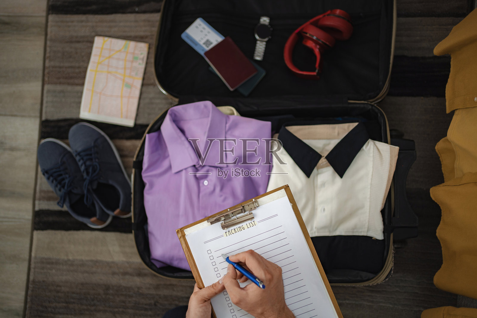 旅行者在准备公事包时检查打包清单照片摄影图片
