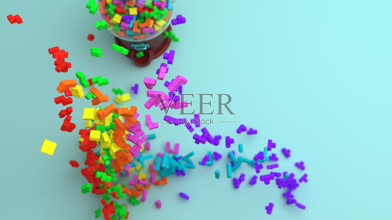 四个方块形状的积木在一个装有积木的糖果机前方落下。照片摄影图片