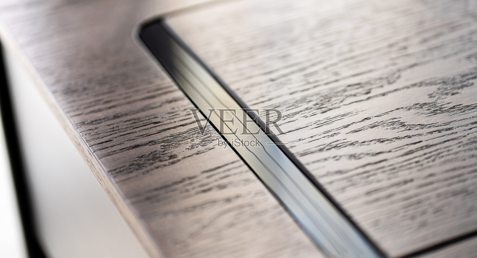 桌子上的无线充电器与手机。现代办公配件照片摄影图片