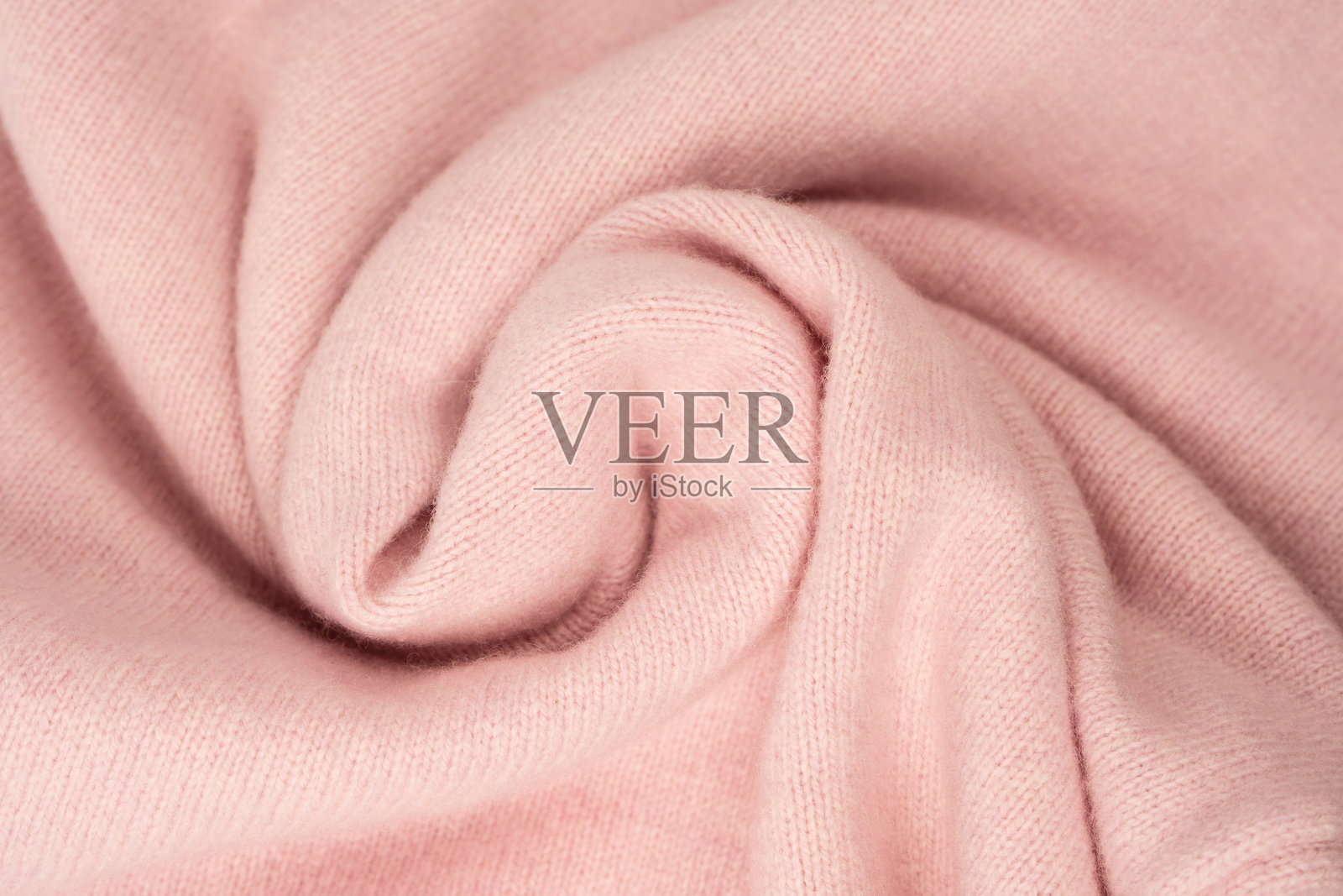 柔和粉色的开司米毛衣纹理背景。照片摄影图片