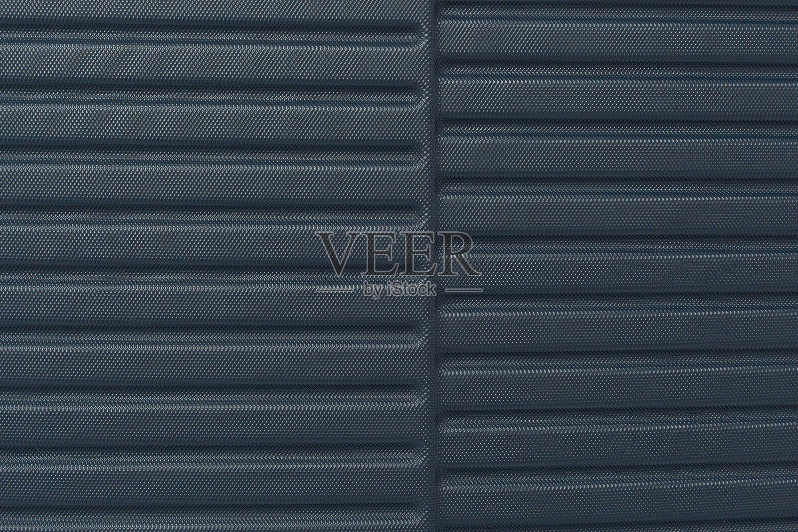 蓝色硬壳行李箱的纹理特写。照片摄影图片