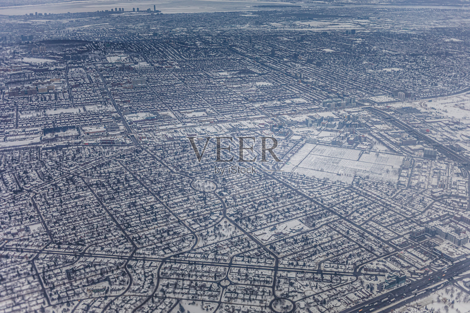 雪覆盖的城市景观鸟瞰图，展示冬季的房屋和道路照片摄影图片