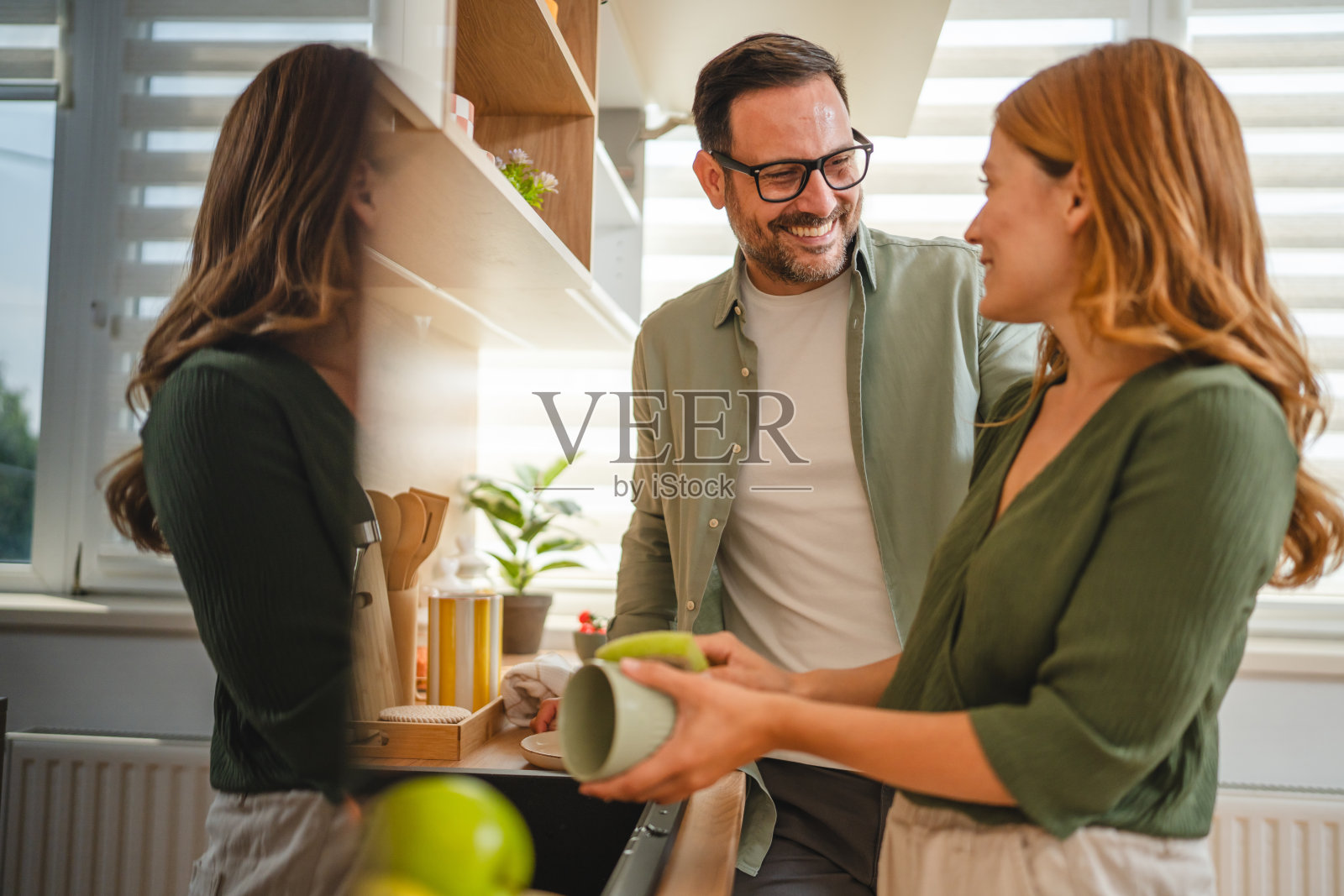 快乐的情侣在现代厨房一起洗碗照片摄影图片