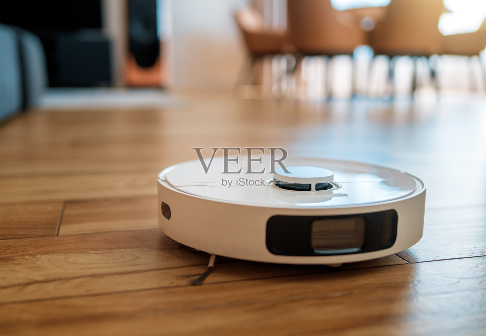 白色机器人吸尘器在木地板上照片摄影图片