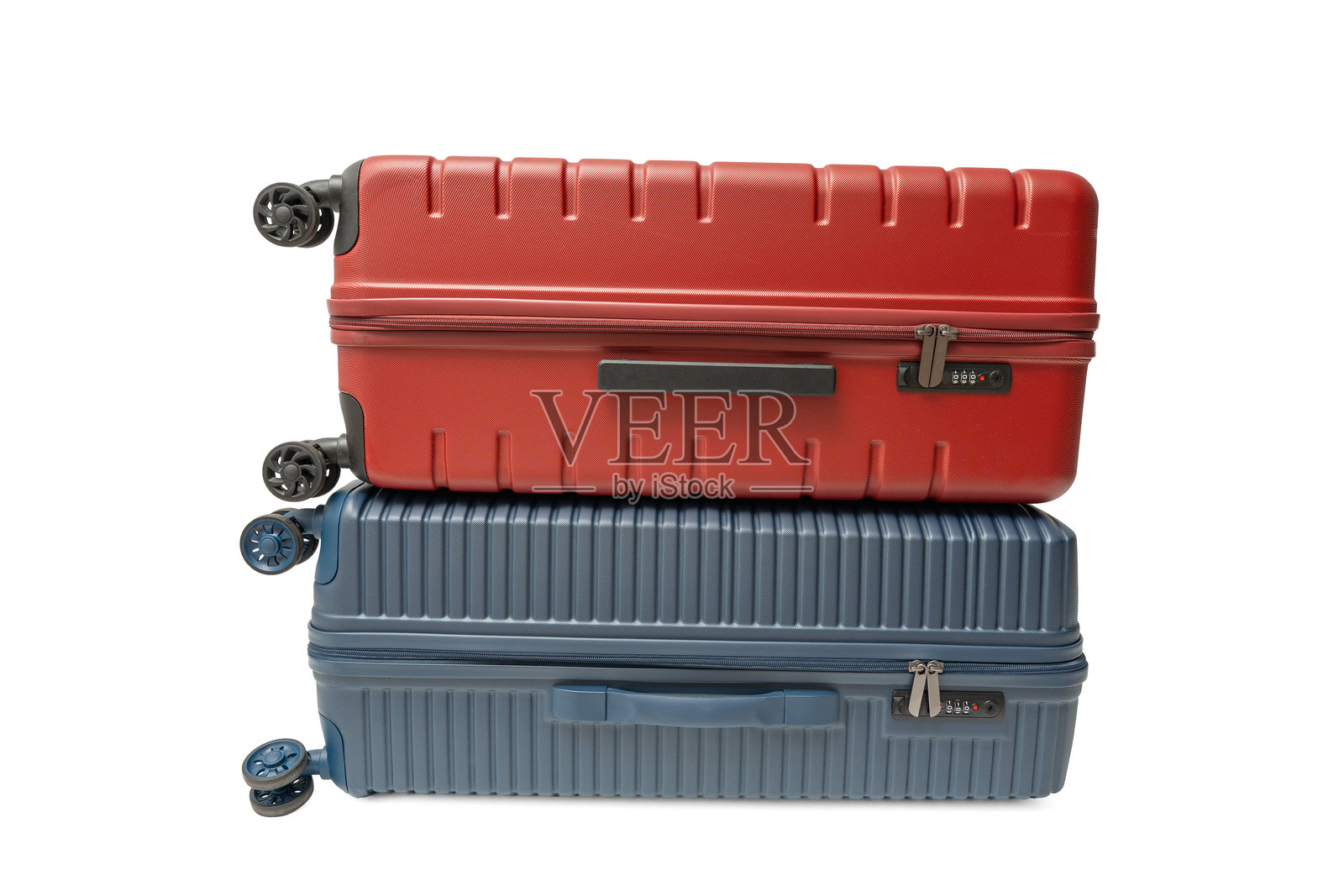 两个硬壳行李箱，红色和蓝色，叠放在一起。照片摄影图片