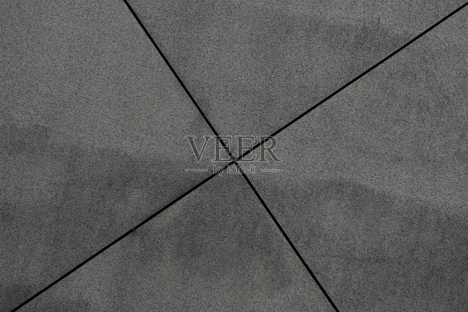 深灰色混凝土表面的特写，带有交叉的对角线。照片摄影图片