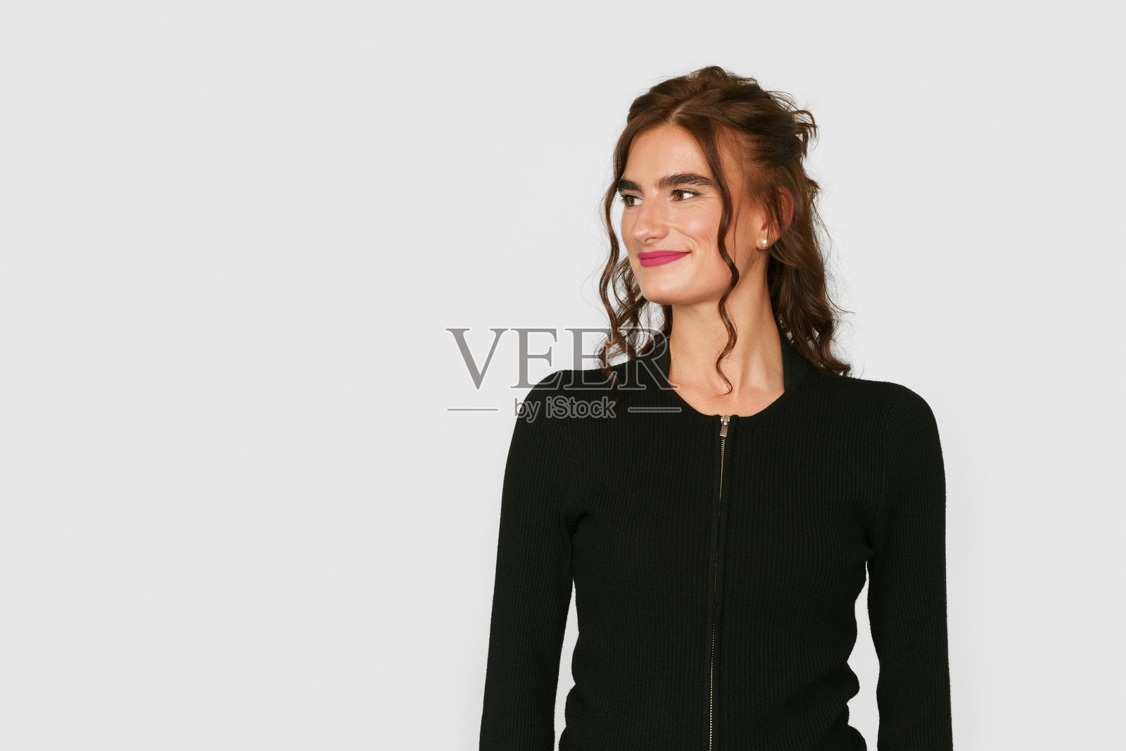 年轻女性在白色背景下侧身沉思的工作室肖像照片摄影图片