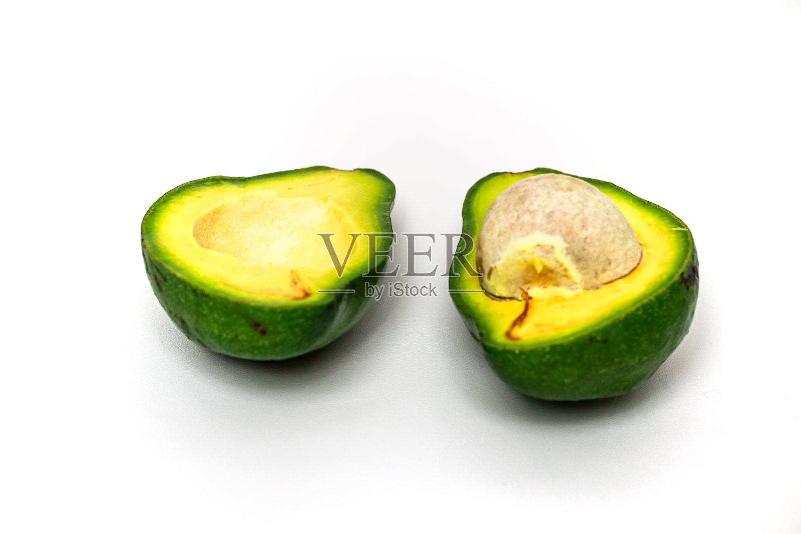 白色背景上的半个牛油果：新鲜健康的食材展示照片摄影图片