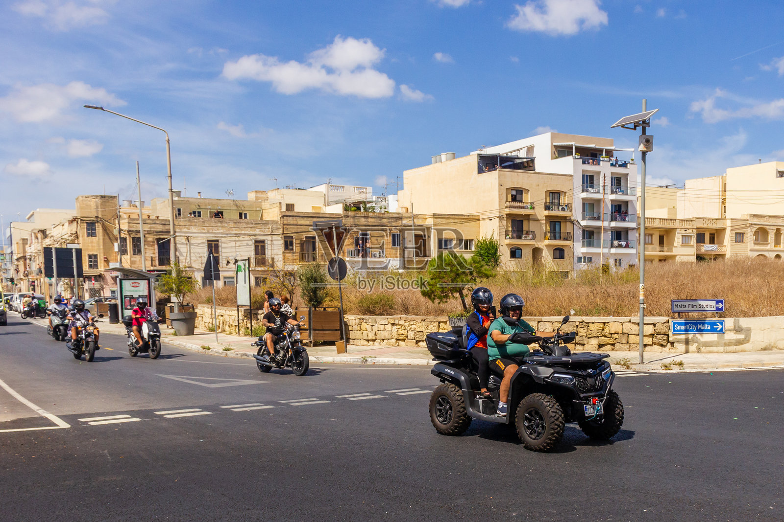 装饰车辆和摩托车手的宗教游行队伍在城市地区行进照片摄影图片