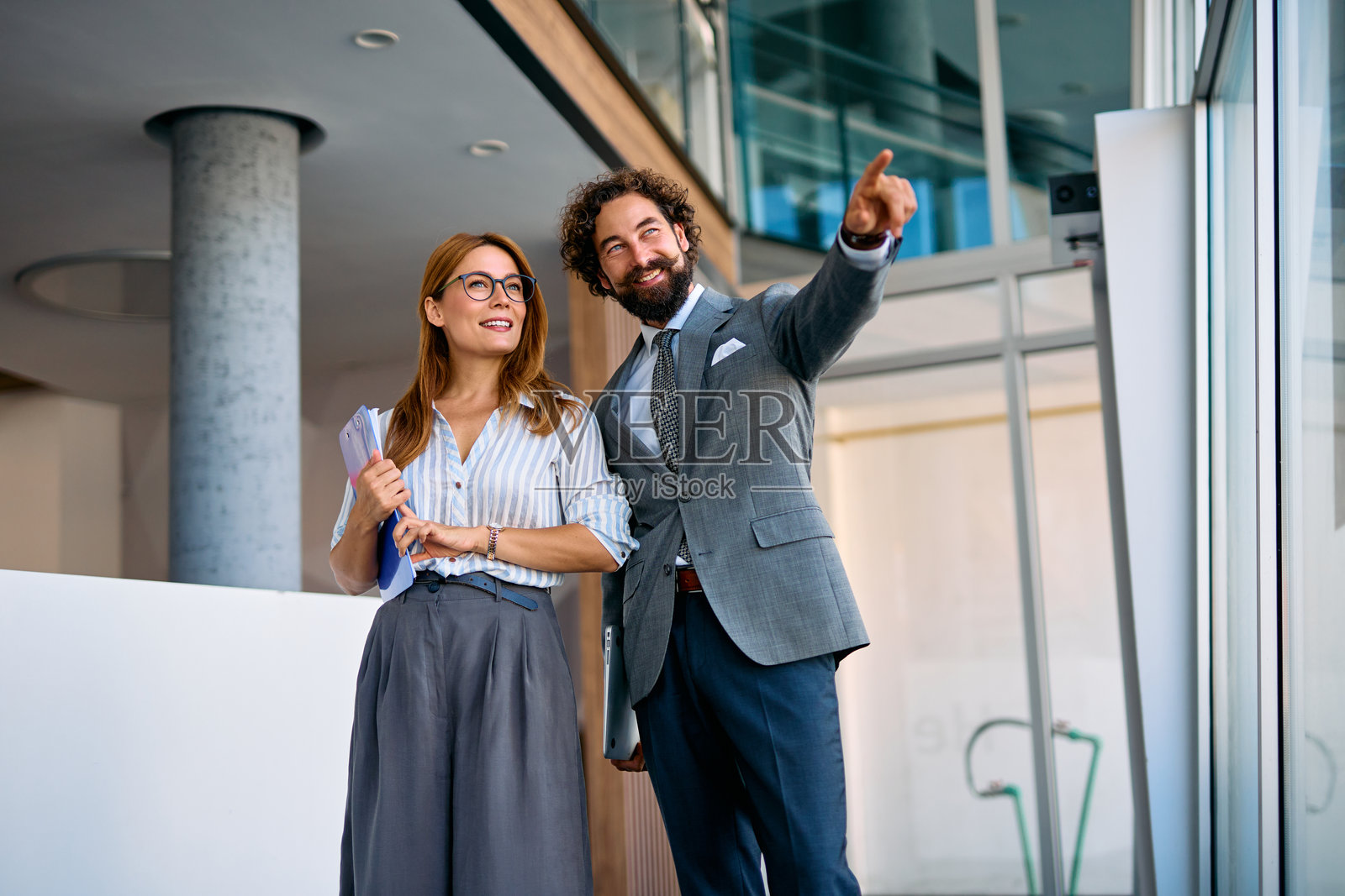 办公室的同事们正在讨论成功的未来战略，并指向它。照片摄影图片