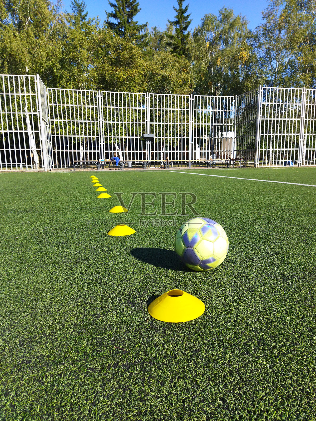 阳光明媚的日子里，使用标志桶进行的足球训练演练照片摄影图片