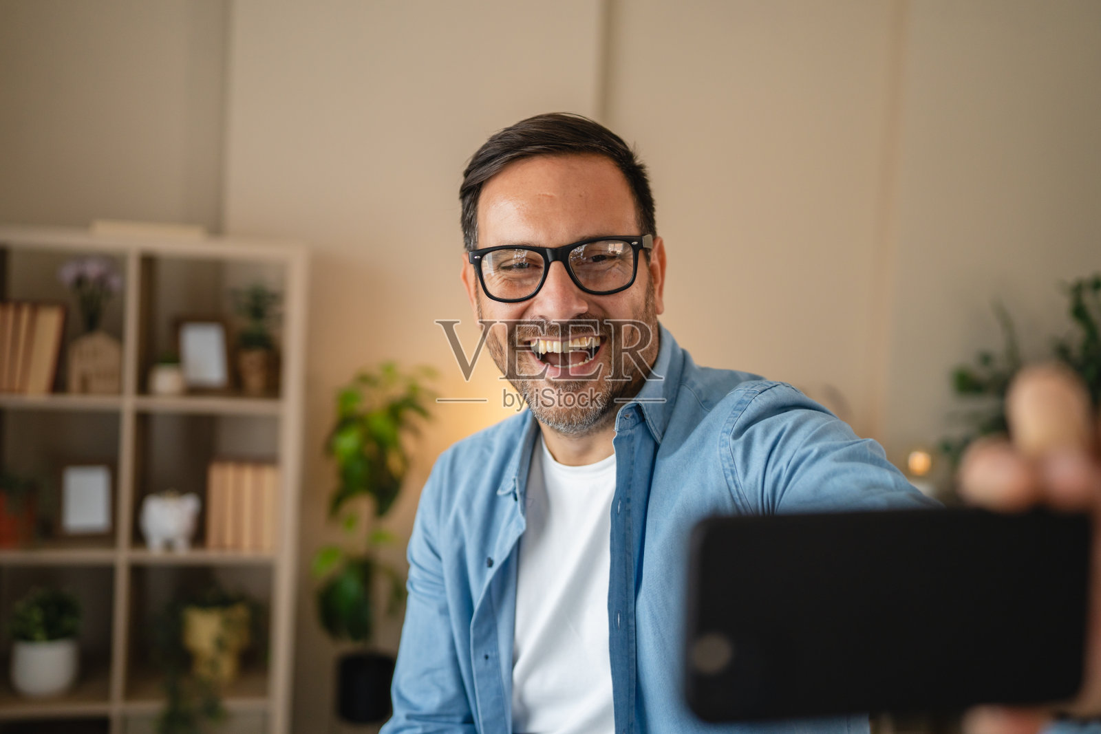 男人用智能手机自拍大笑照片摄影图片