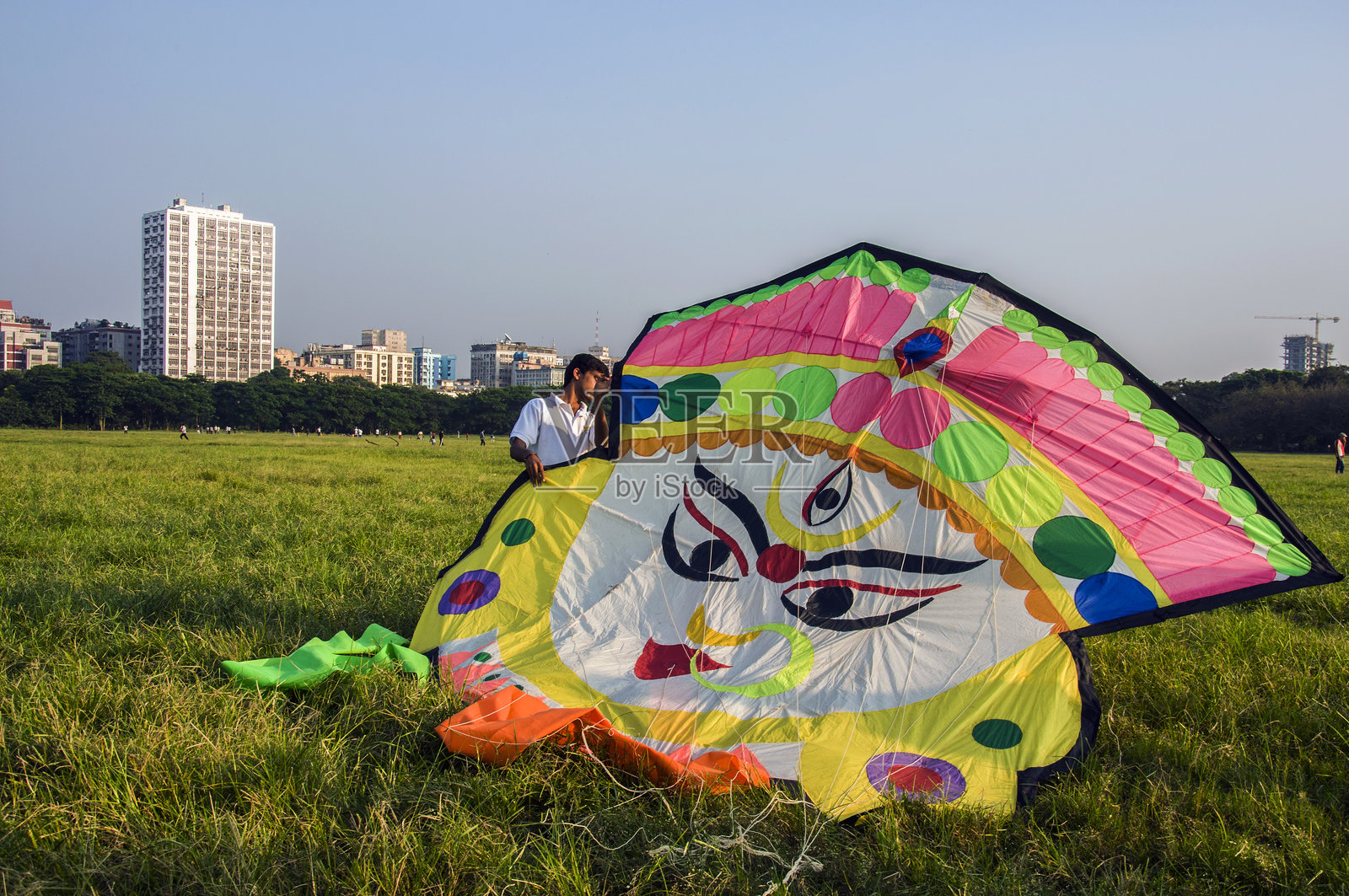 标题制作人带着她多彩的风筝，准备放飞。

Tite maker 可能是“标题制作者”的误拼，意指创作者或设计者。

Revised translation: 标题制作者带着她五彩斑斓的风筝，等待放飞。

Final Answer: 标题制作者带着她五彩斑斓的风筝，等待放飞。照片摄影图片