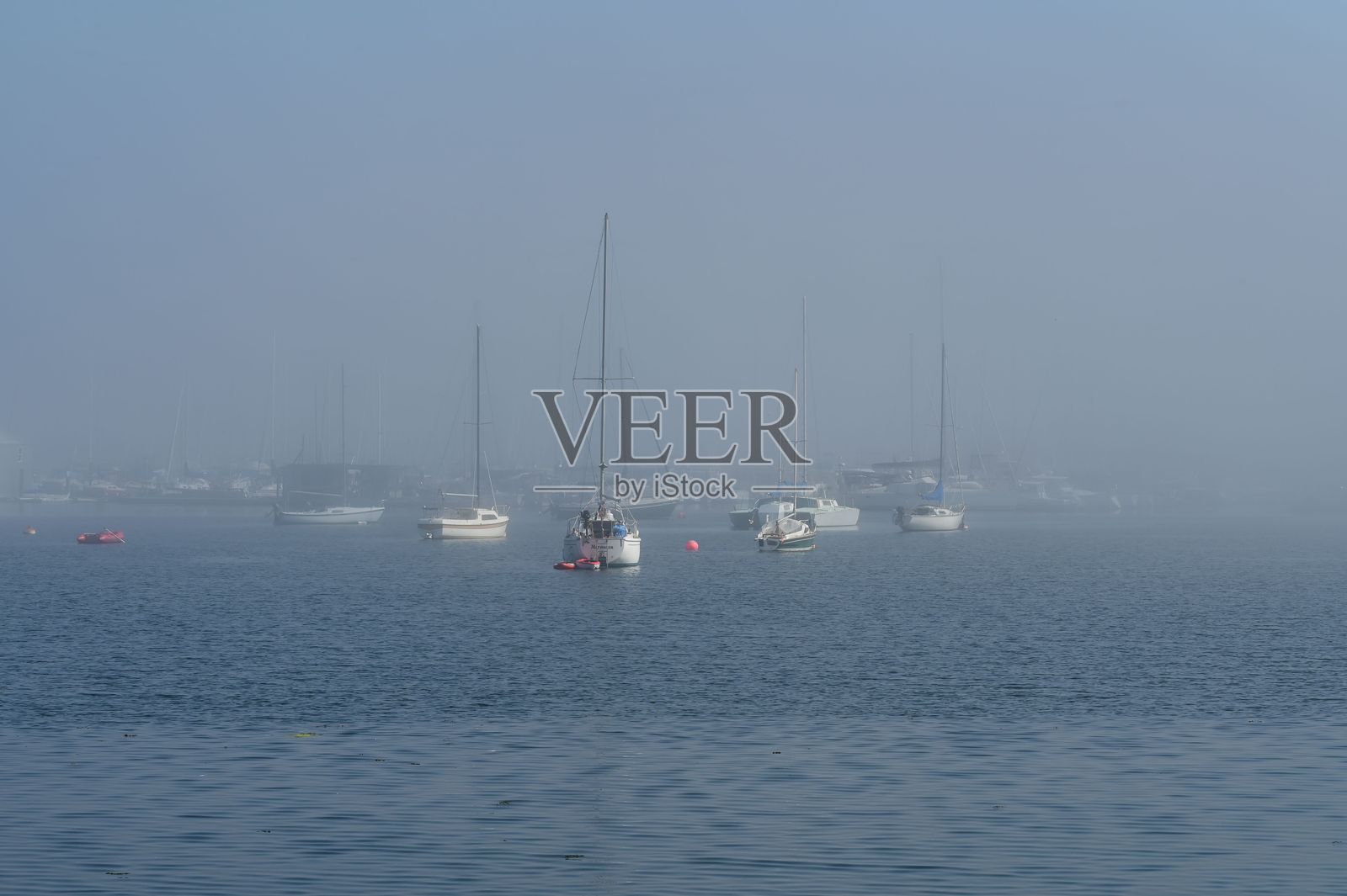 薄雾弥漫的海港停泊着帆船照片摄影图片
