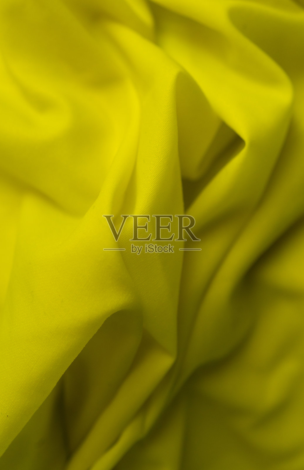 黄色缎面布料作为背景，特写。纺织品背景照片摄影图片