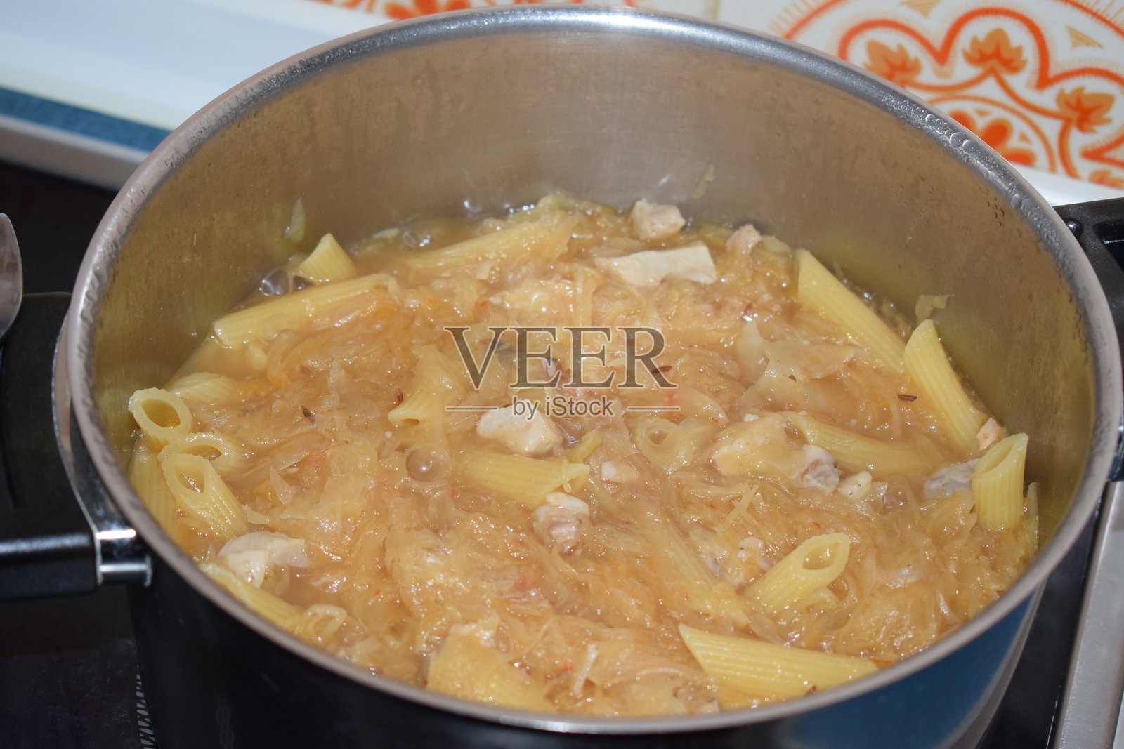 砂锅里的意面配酸菜酱照片摄影图片