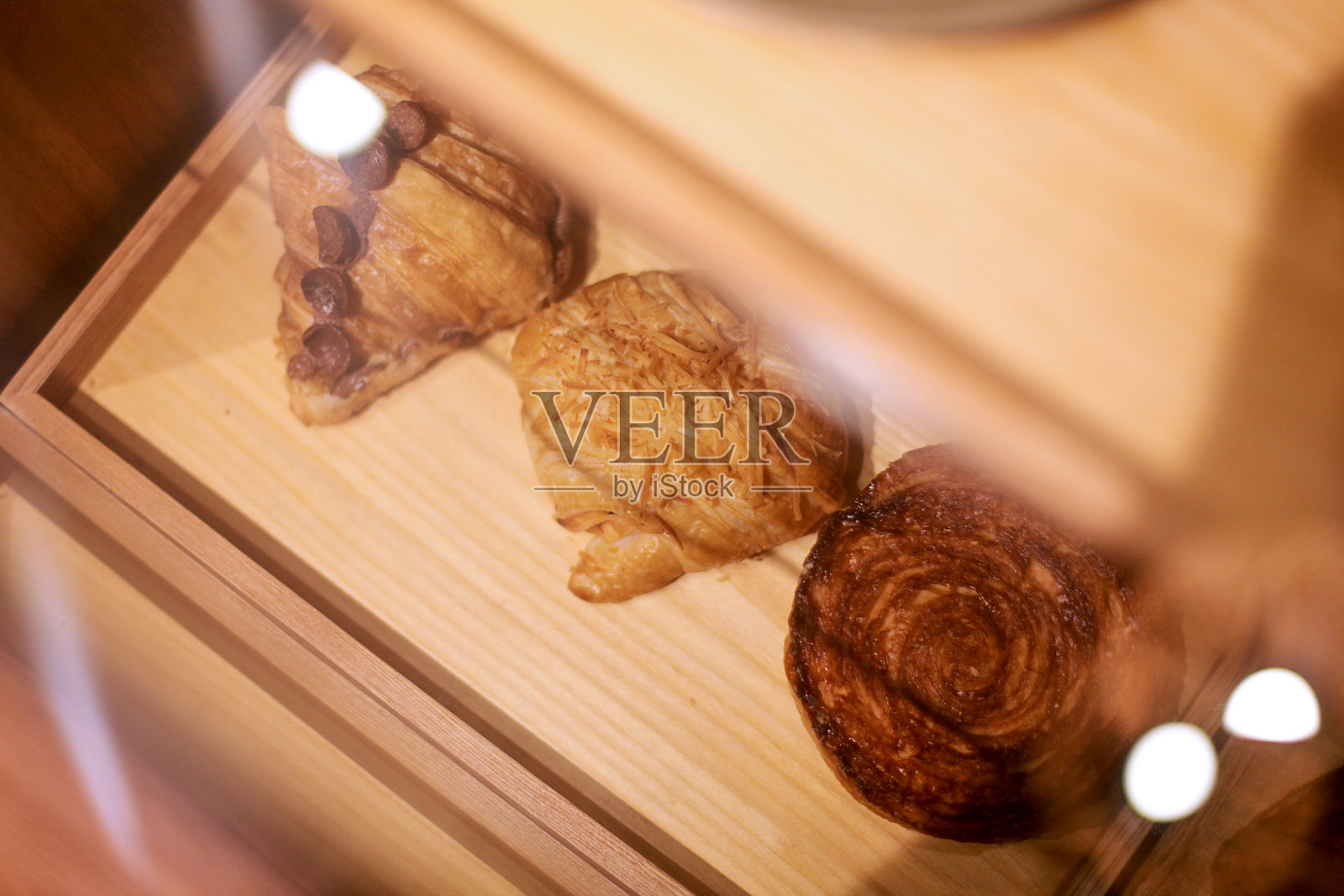 新鲜出炉的羊角面包放在木盘上照片摄影图片