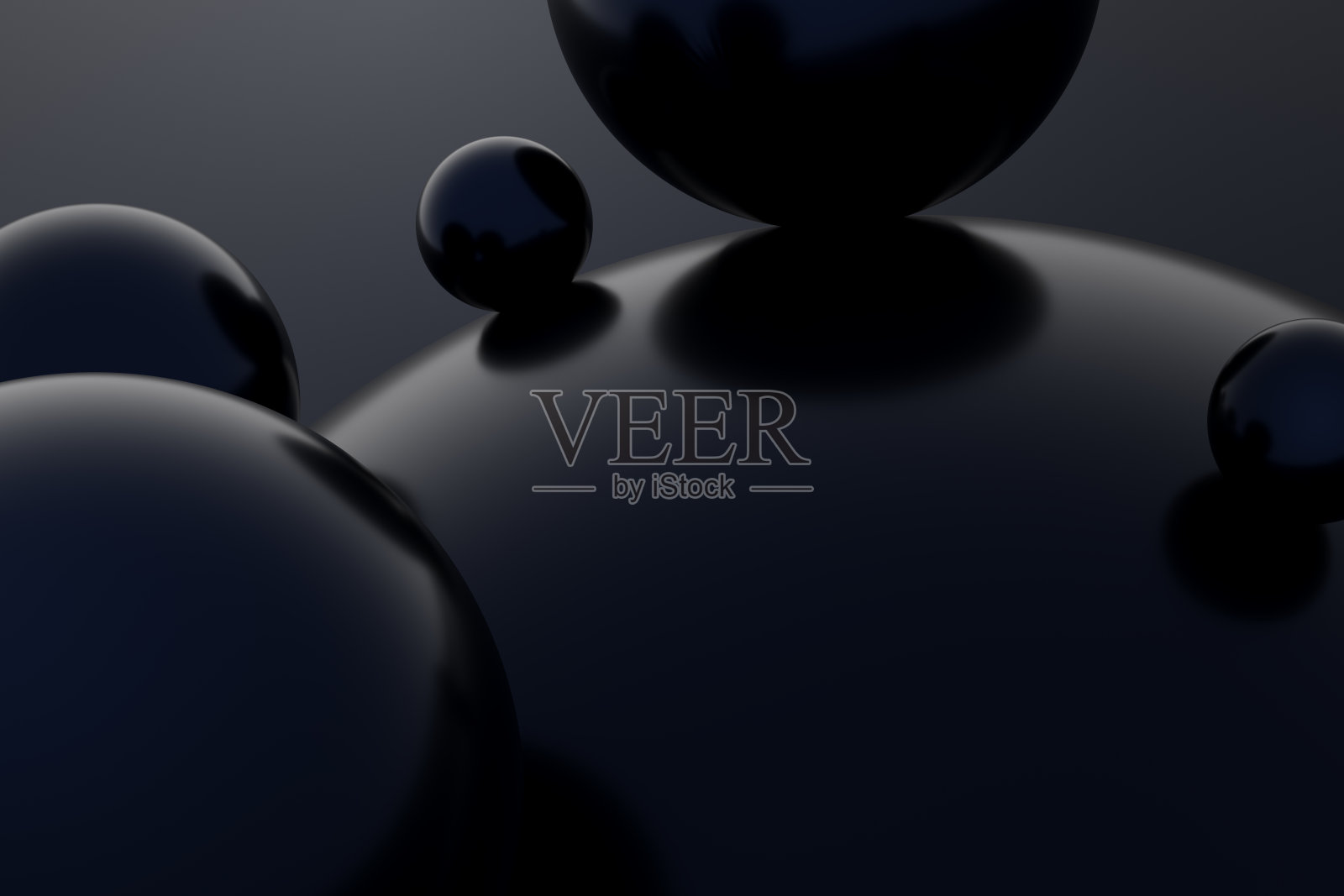 光滑表面上放置着深色光泽球体，构成简约、抽象、现代的构图照片摄影图片