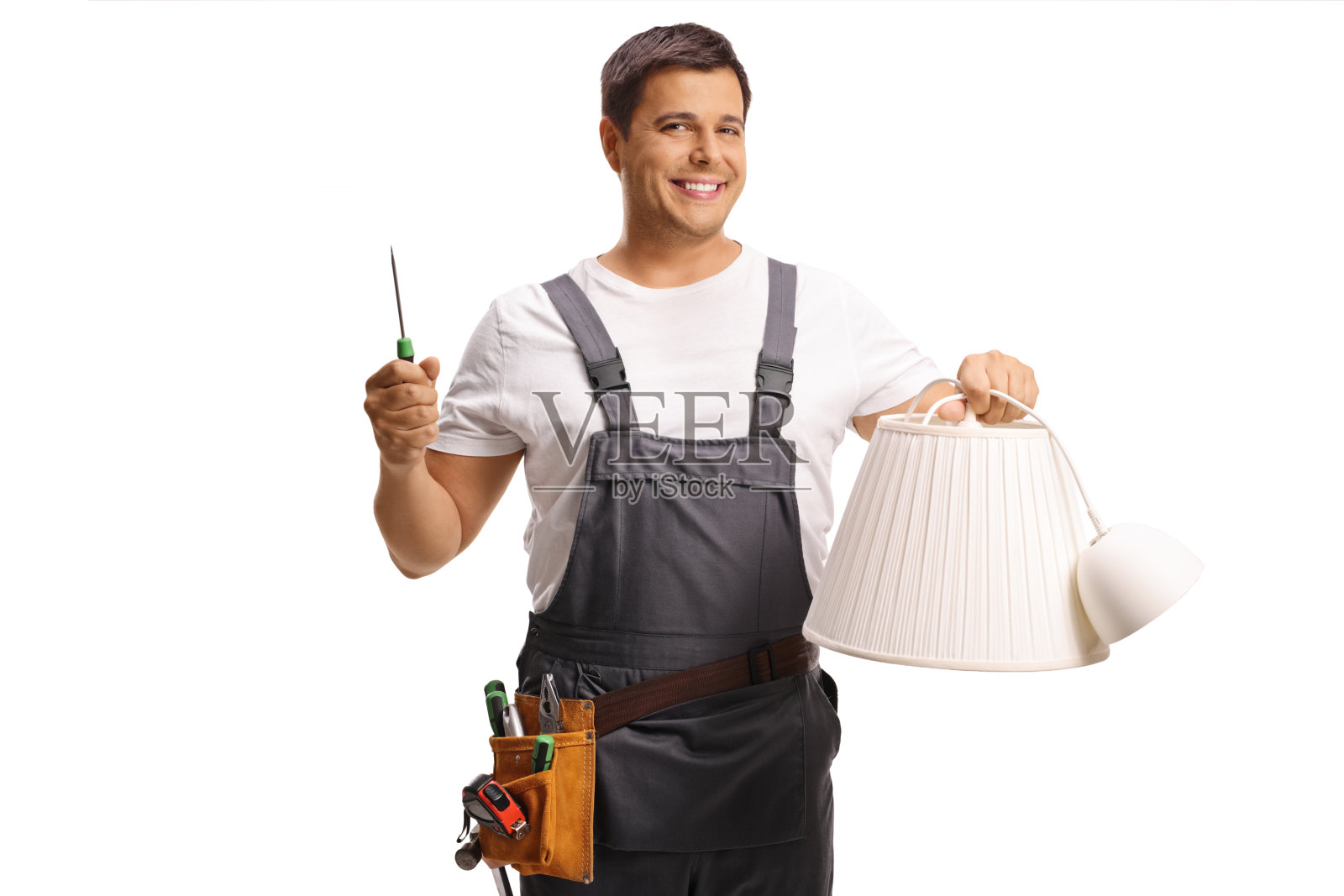 工人手持灯罩和螺丝刀照片摄影图片