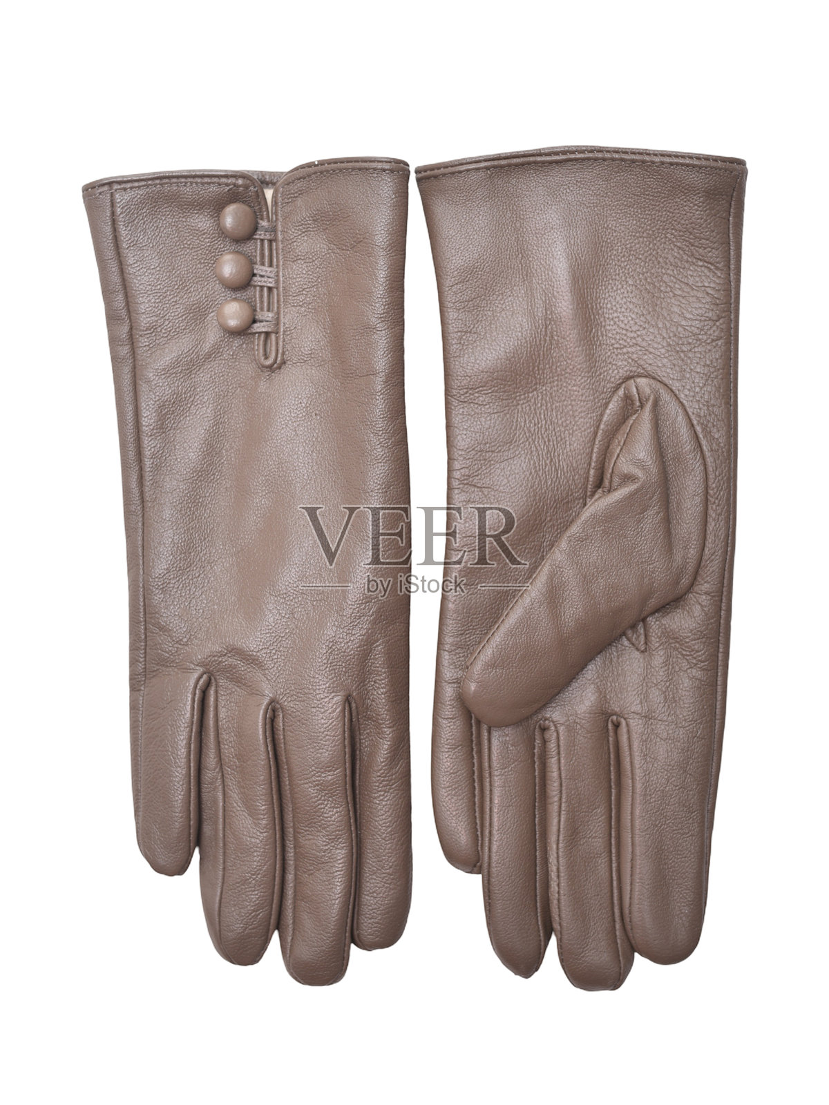 一对优雅的棕色皮革手套，带有纽扣细节，展现精湛的工艺和纹理，是时尚配饰和冬季服装的理想选择，可提升风格和保暖性。照片摄影图片