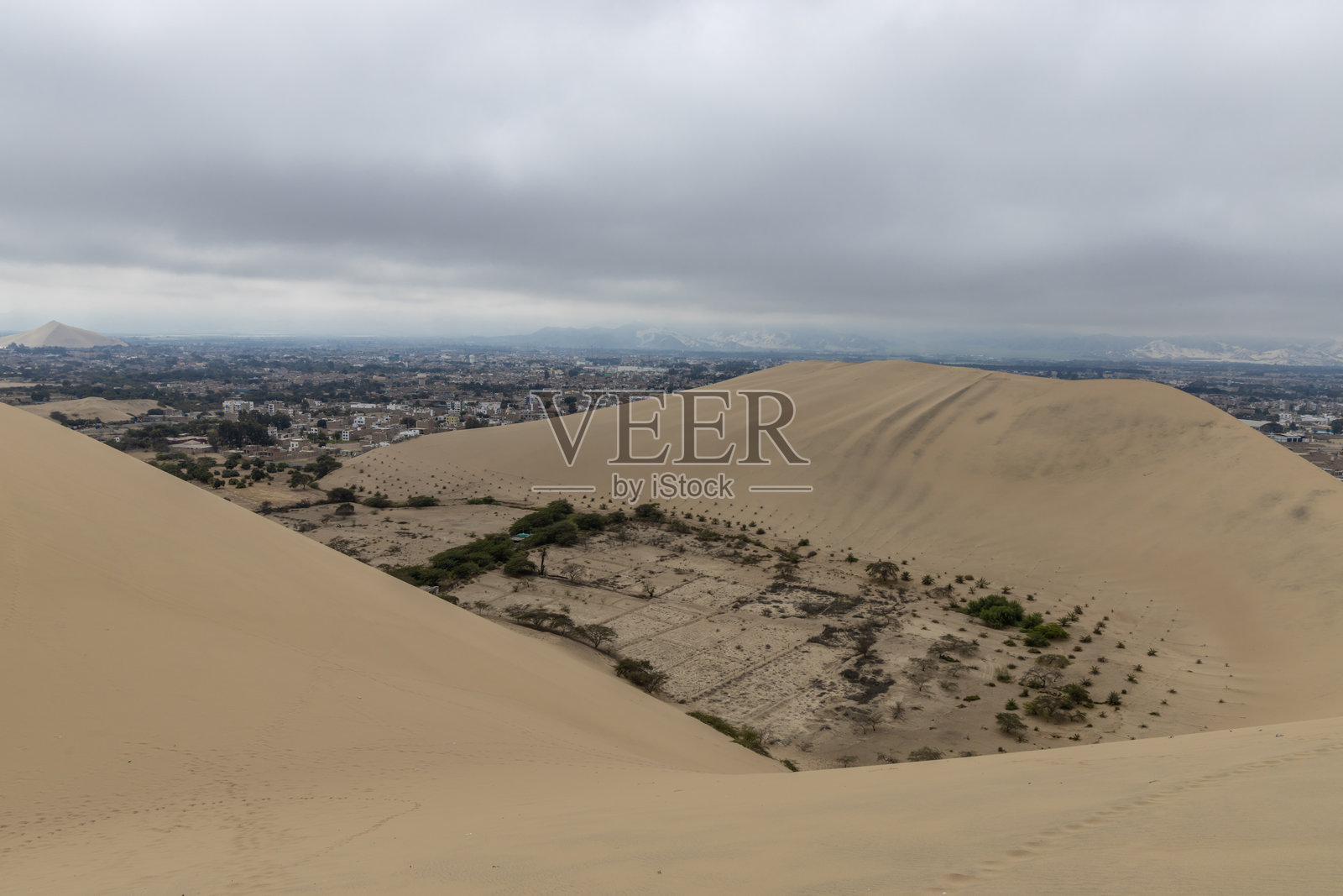 伊卡市的沙丘。湖泊和棕榈树，四周环绕着秘鲁海岸沙漠中的沙丘。位于瓦卡奇纳绿洲和度假胜地的伊卡沙丘。照片摄影图片