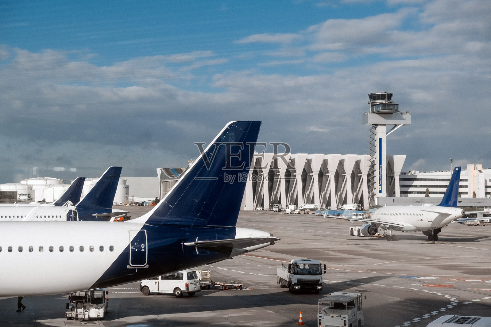 停在机场航站楼的飞机和控制塔照片摄影图片