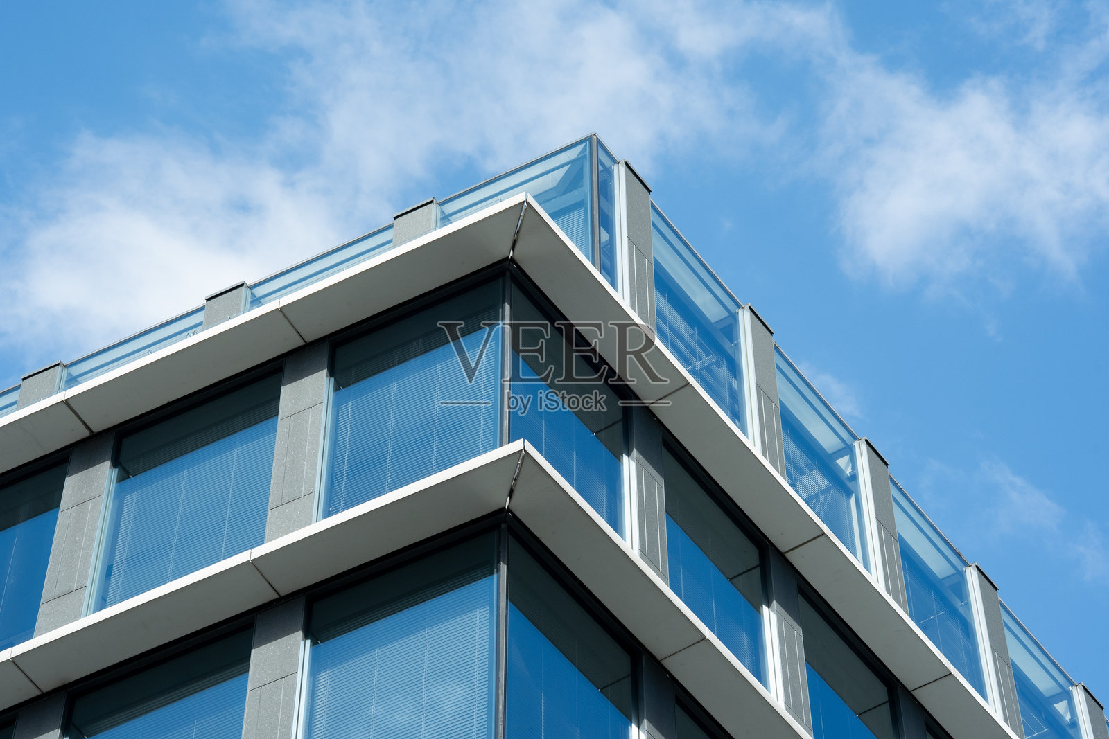 蓝天下的现代玻璃办公楼照片摄影图片