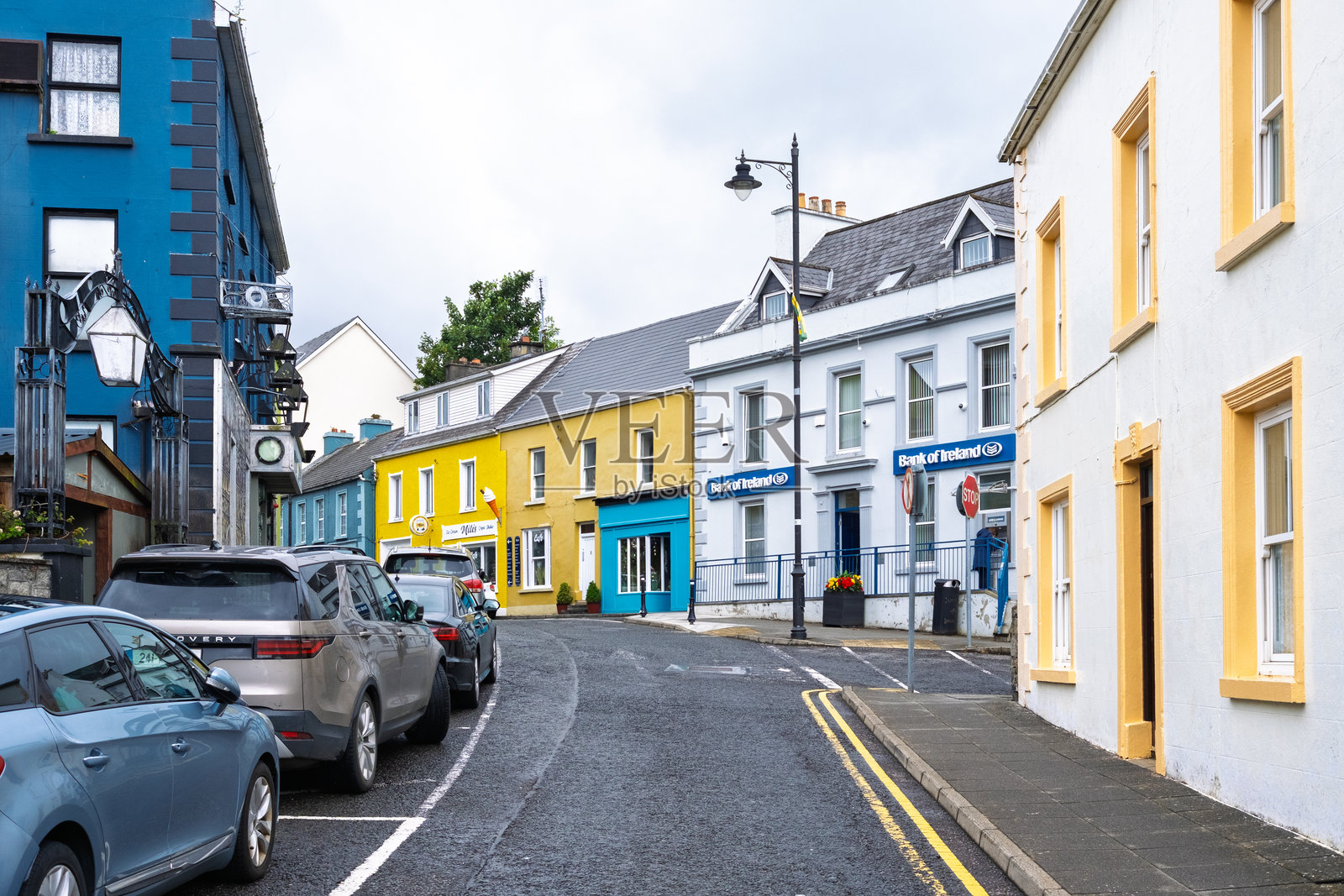 2025年7月3日，爱尔兰都柏林：迷人的海岸村庄街道，色彩缤纷的建筑和爱尔兰银行分行。照片摄影图片