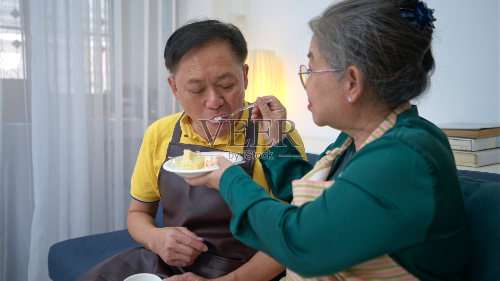 Holiday, elderly couple testing handmade desserts at home照片摄影图片