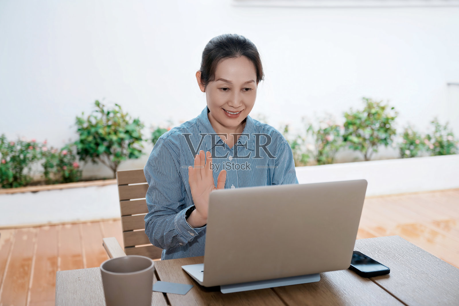女子在户外通过笔记本电脑进行视频通话照片摄影图片