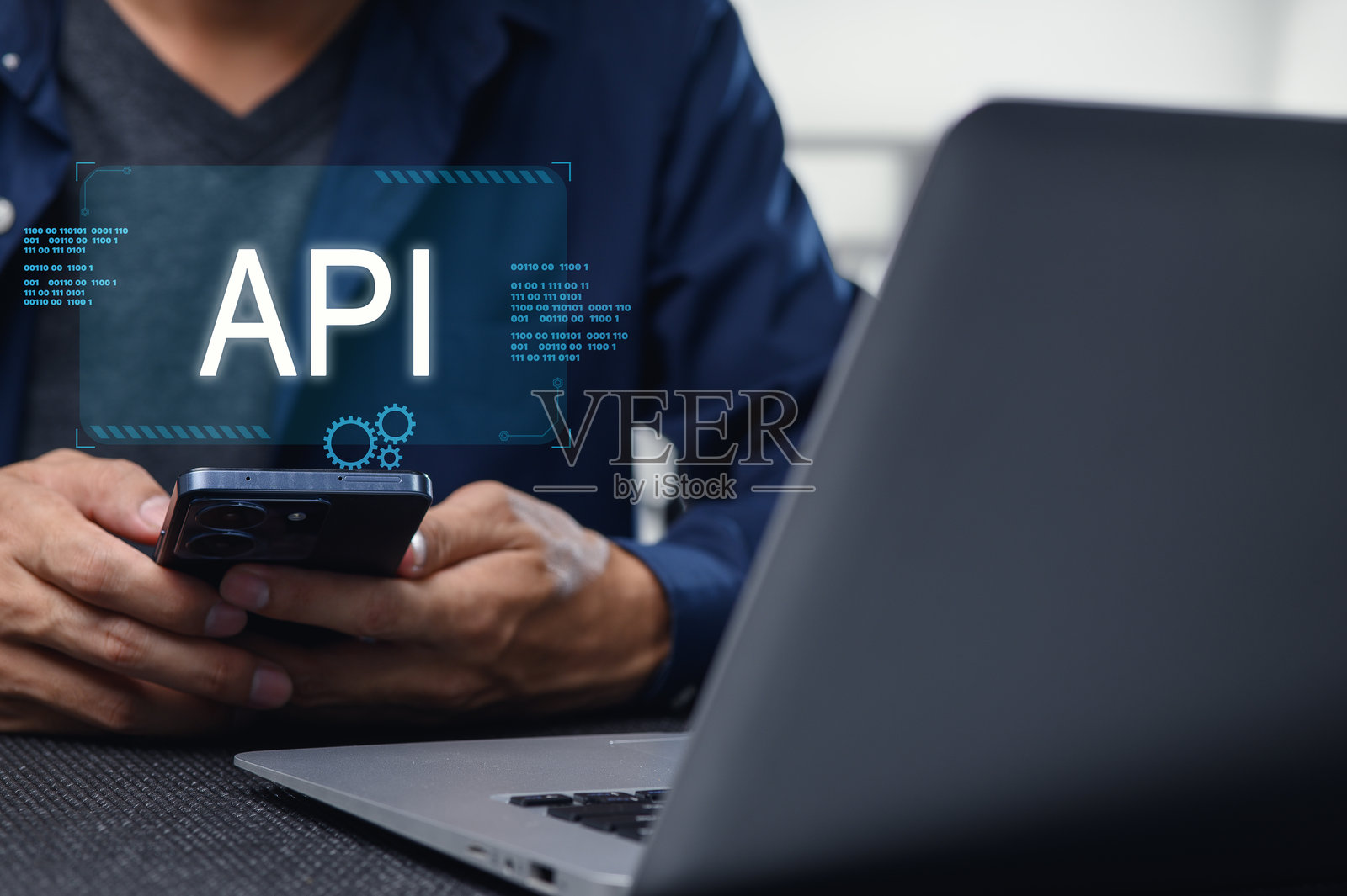 开发人员使用笔记本电脑和手机处理移动 API 界面照片摄影图片