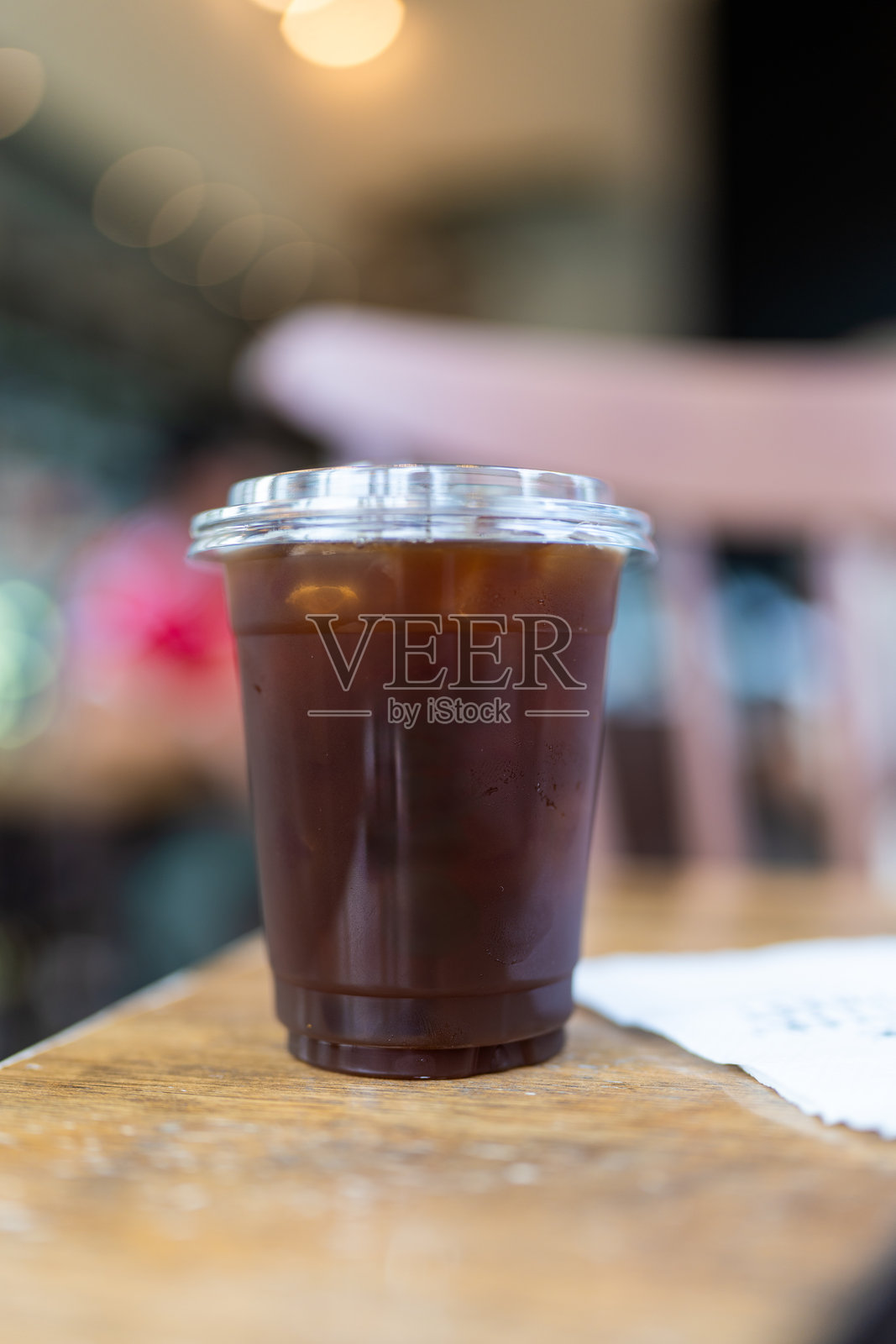 特写：外卖塑料杯装的冰黑咖啡照片摄影图片