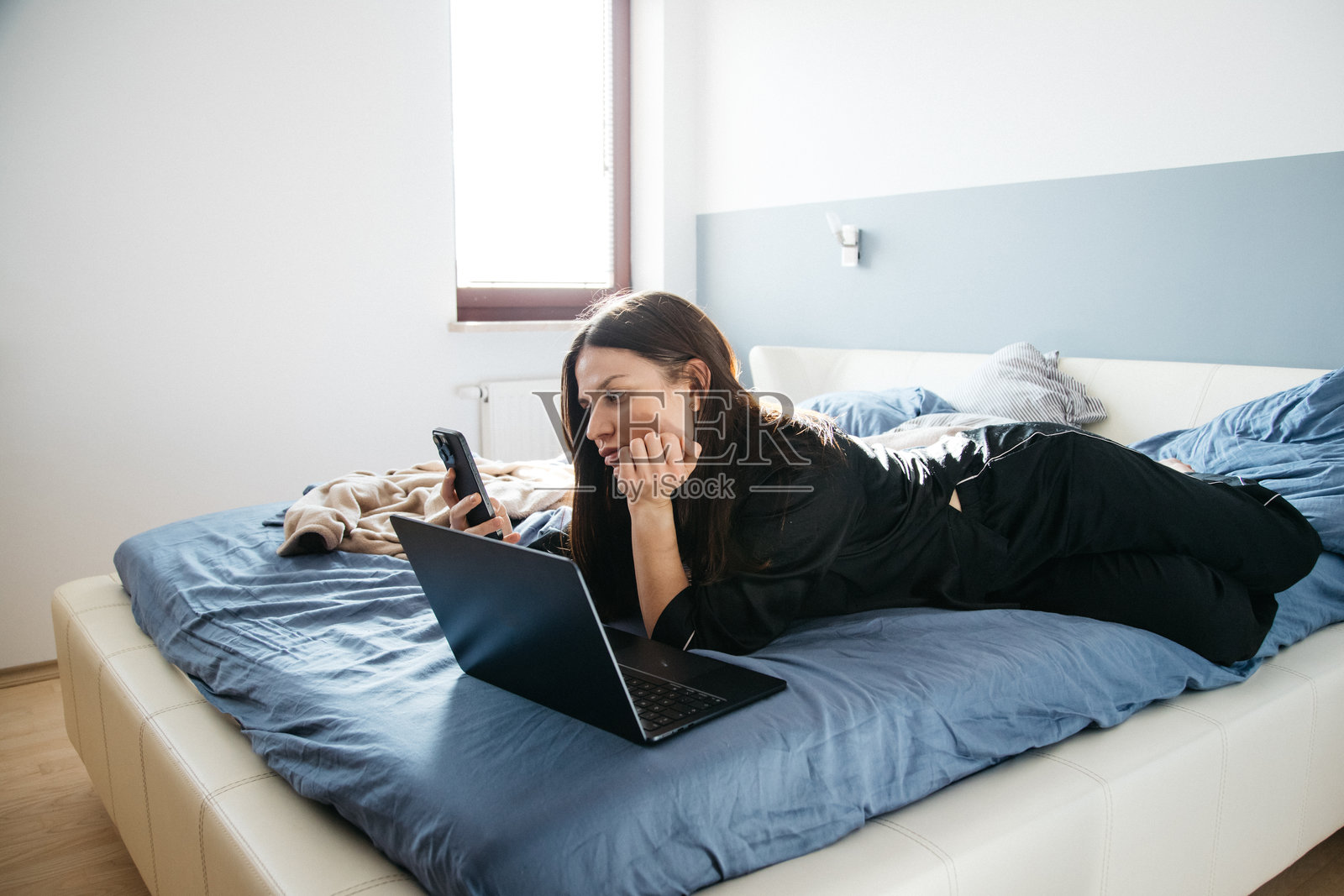 穿着睡衣的年轻女孩在家办公照片摄影图片