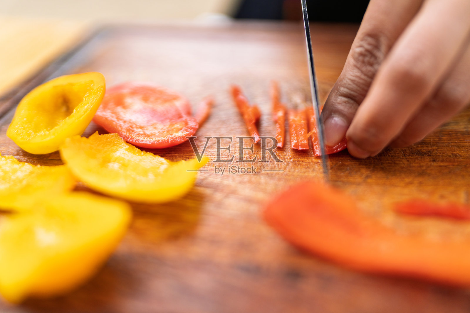 一个人正在切菜板上切甜椒，准备制作新鲜餐点照片摄影图片