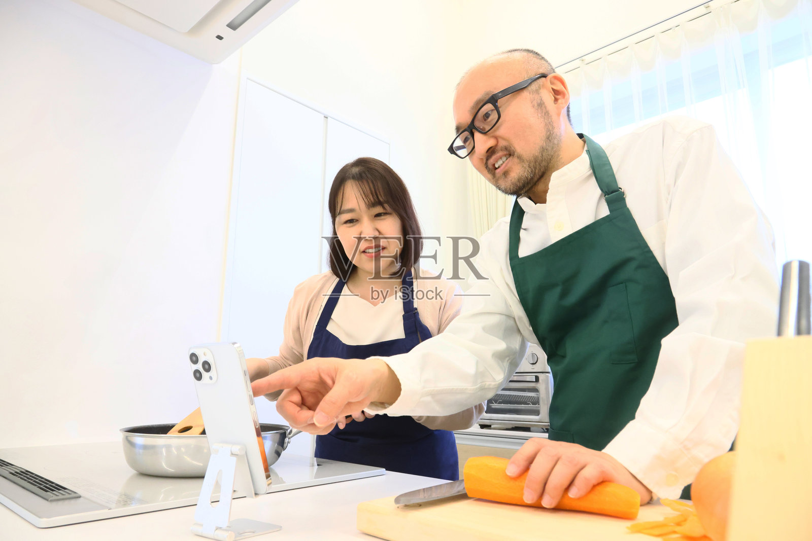 中年夫妇在厨房烹饪照片摄影图片