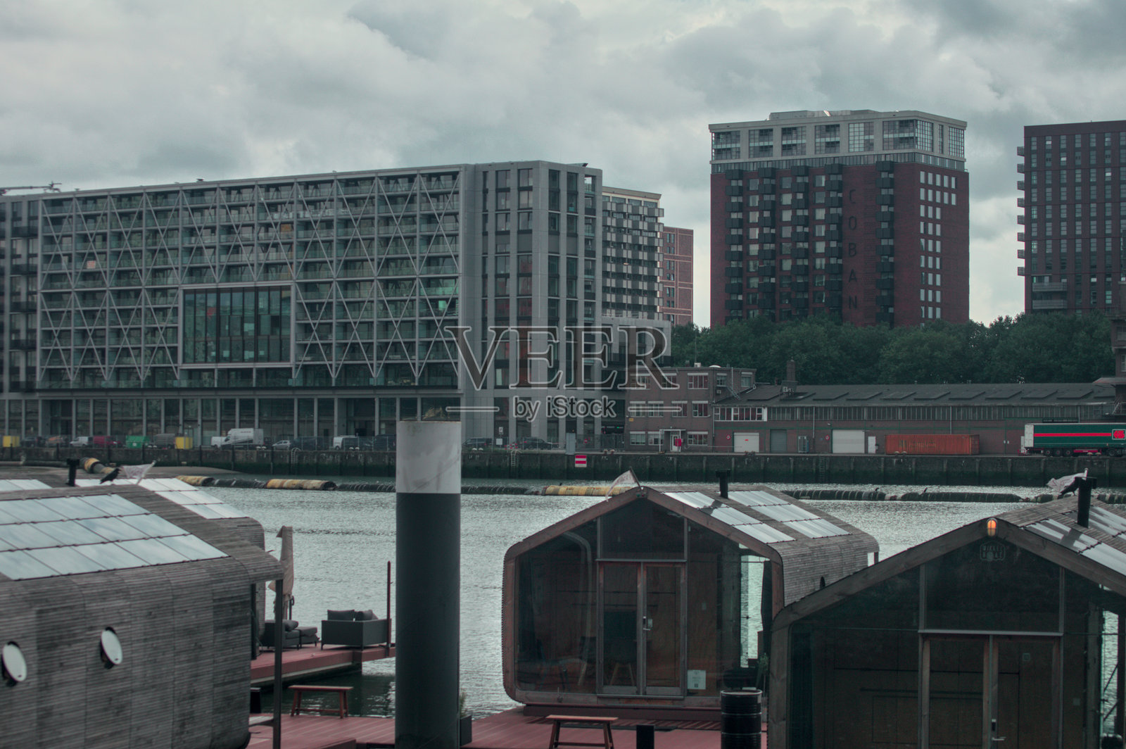 位于马斯特哈芬诺德济德街的Wikkelboats、微型房屋船和摩天大楼，展示了鹿特丹的奢华与现代北方建筑风格。照片摄影图片