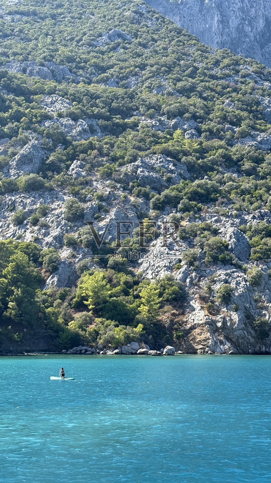碧绿的海水和山峰在晴朗的天空下照片摄影图片