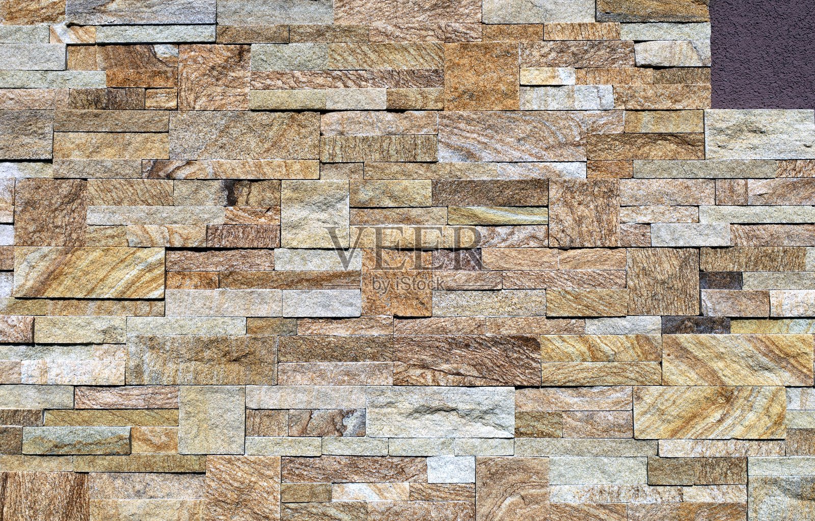 优雅的墙面石材覆盖物，由砖块和立方体构成。颜色有黄色、棕色、白色和灰色。照片摄影图片