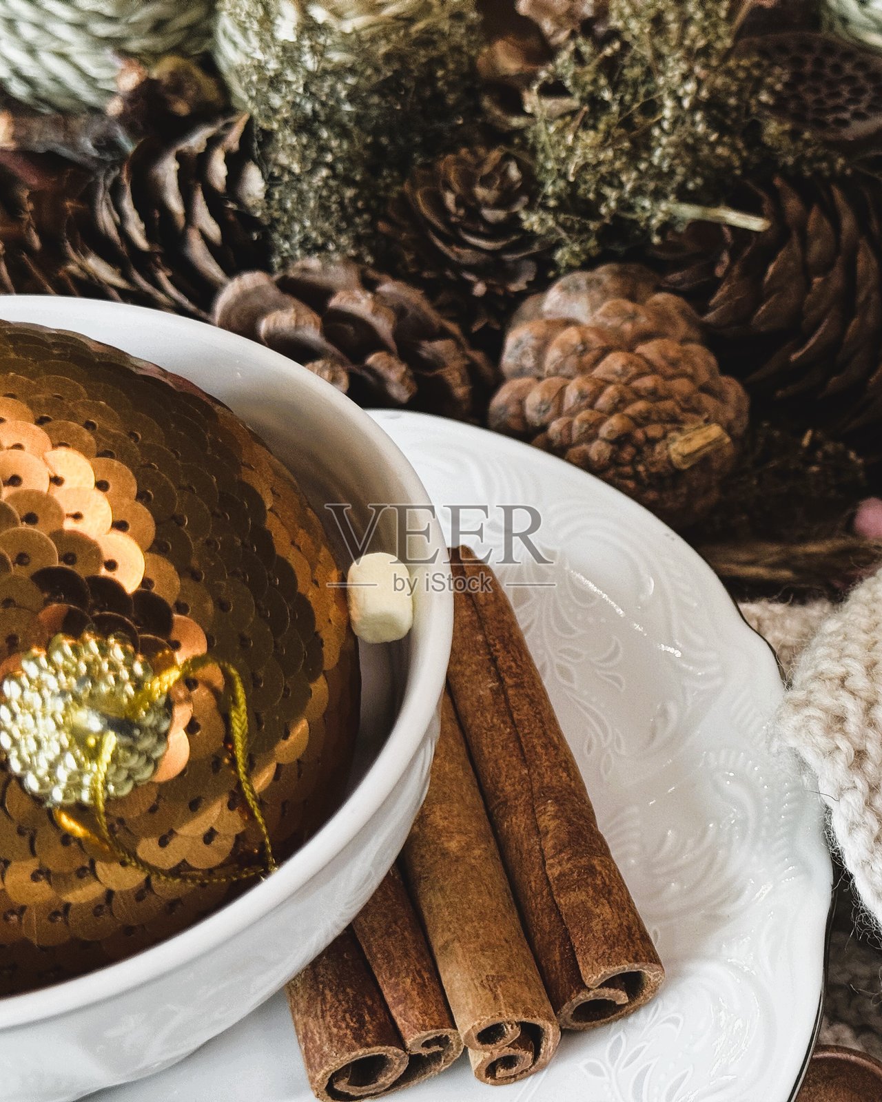 特写镜头：舒适的针织品和松果，质朴的冬季装饰。照片摄影图片