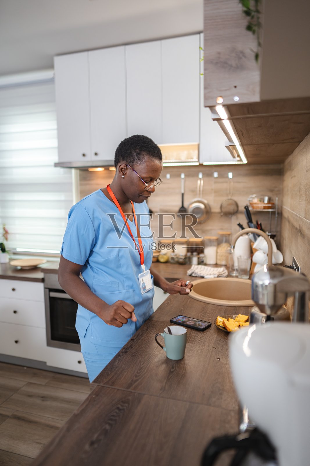 护士在厨房吃早餐时查看手机照片摄影图片