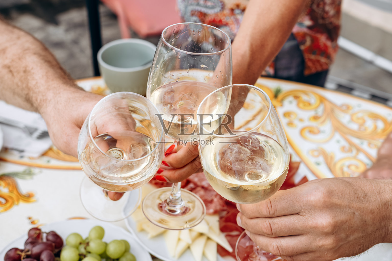 一群朋友在热闹的聚会上举杯庆祝，在充满活力的户外环境中共同分享喜悦照片摄影图片