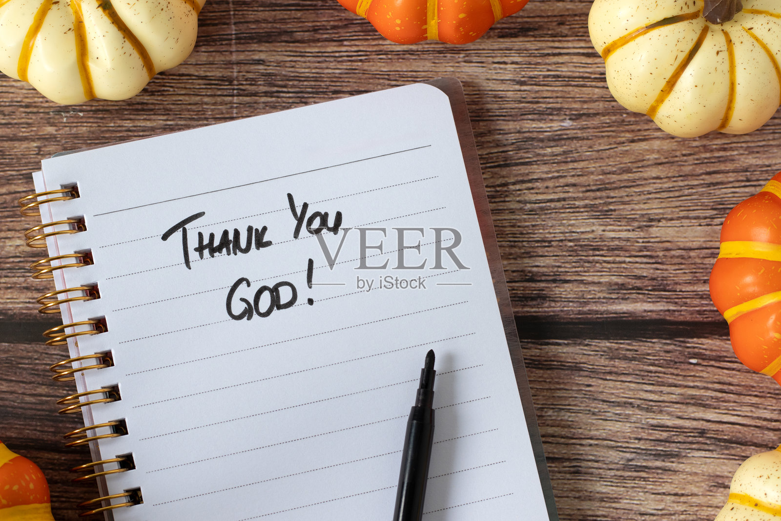 我今天很感恩，笔记本上的手写文字，配以木质背景上的南瓜。照片摄影图片