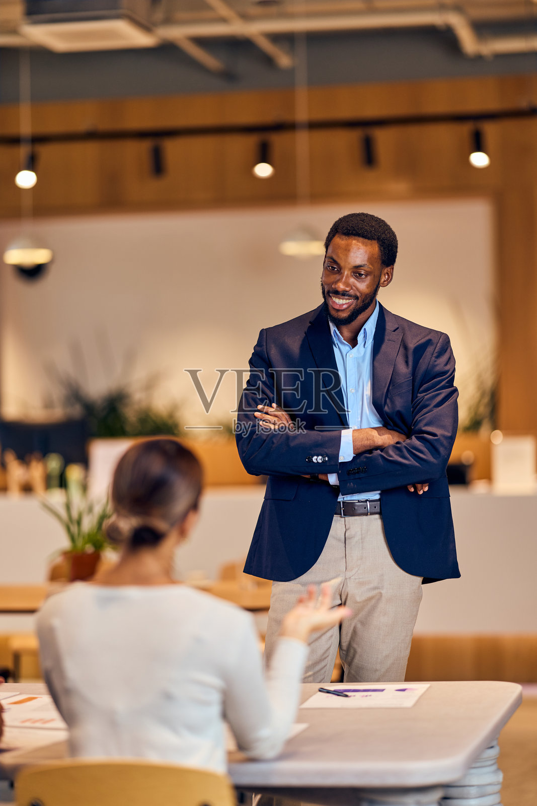 自信的非裔美国男性穿着西装，在办公室会议中与非裔美国女性进行交谈照片摄影图片