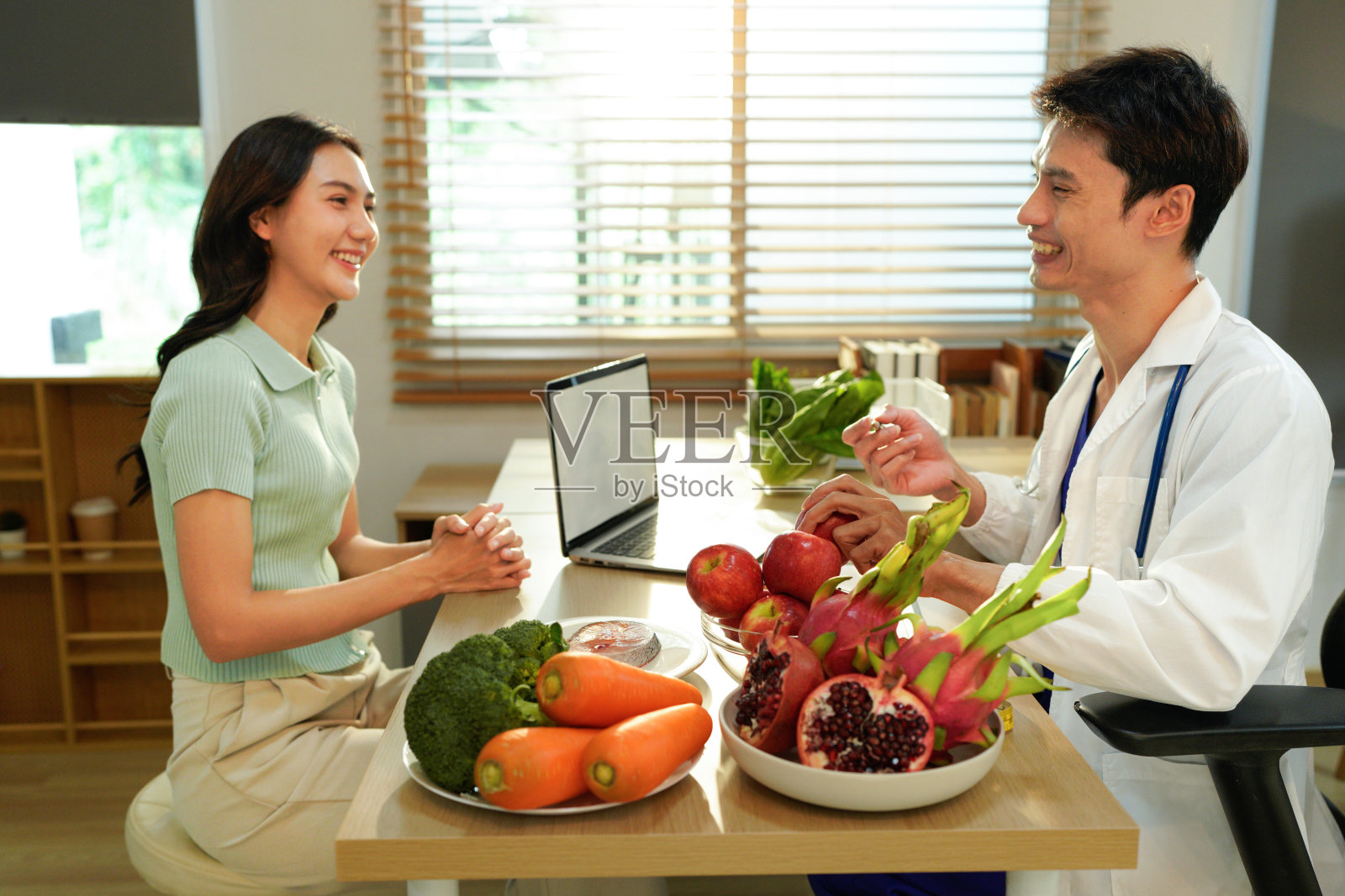 营养师，男性营养专家咨询女性，制定健康饮食、膳食计划。饮食顾问询问、给予男性患者建议、帮助、营养信息、新的膳食计划照片摄影图片