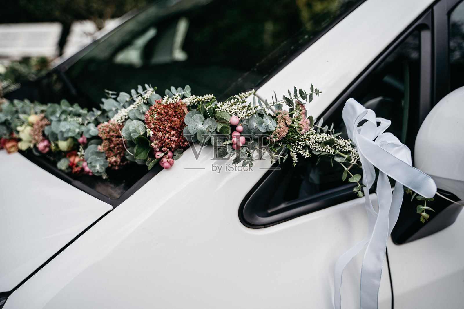 装饰着花束和丝带的白色汽车。照片摄影图片