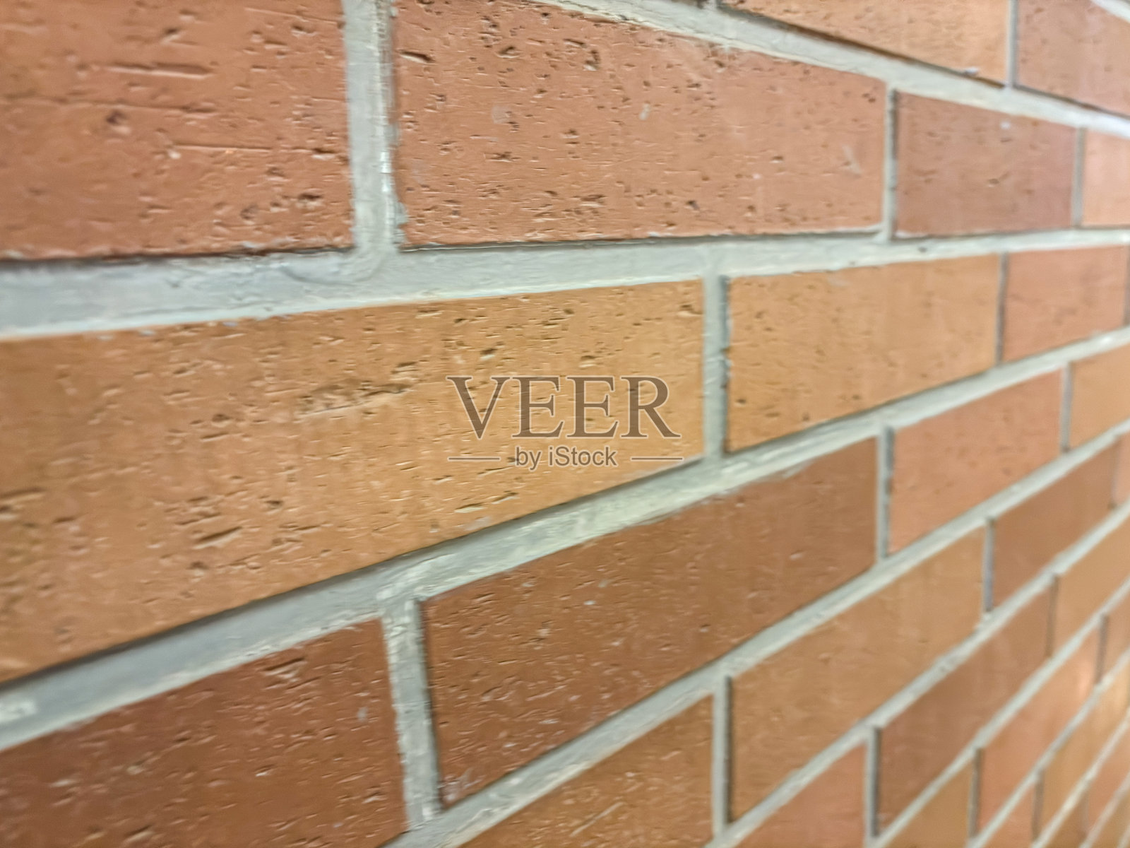 赤陶砖墙，带有干净的灰色砂浆接缝，形成线性纹理图案照片摄影图片